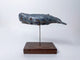 Sperm whale made of ceramics, on a wooden stand