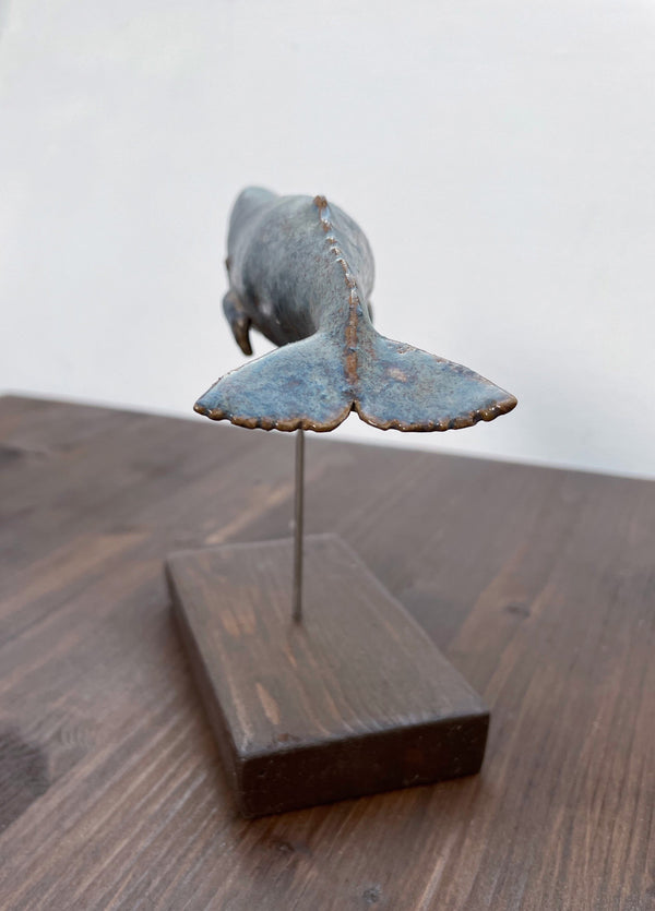 Sperm whale made of ceramics, on a wooden stand