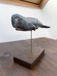 Sperm whale made of ceramics, on a wooden stand