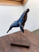 Humpback whale made of ceramics, on a wooden stand, beautiful glaring blue color, glossy