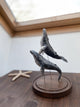 Humpback whales couple on a wooden stand under glass cloche, made of ceramics